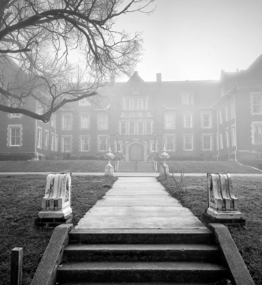 black and white picture of old inn during mistry morning